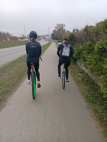 Two people riding unicycles