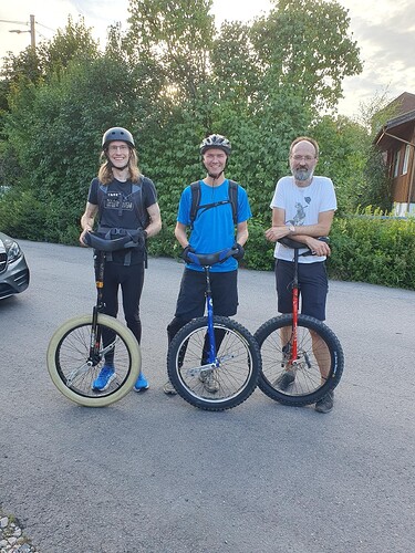 Three men with 24 inch unicycles