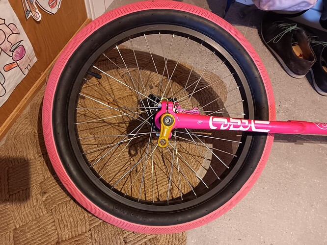 Pink unicycle wheel with gold cranks